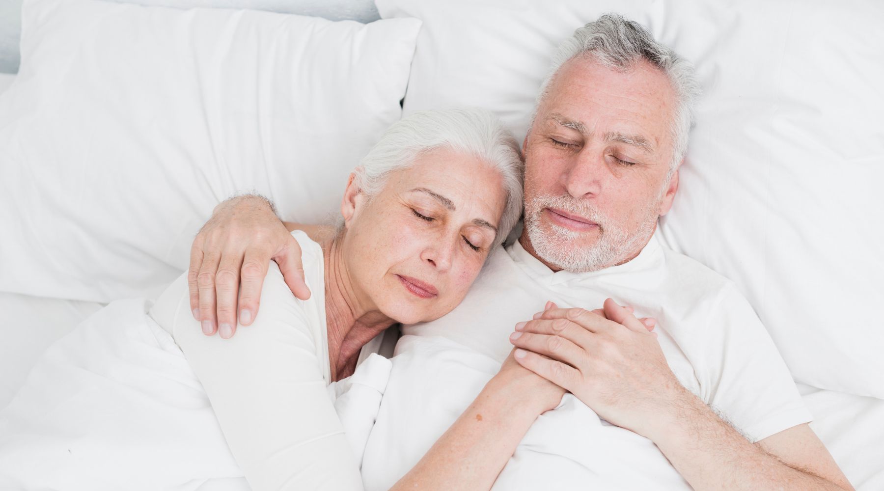 elderly couple sleeping together without risk of back pain because they chose the right mattress