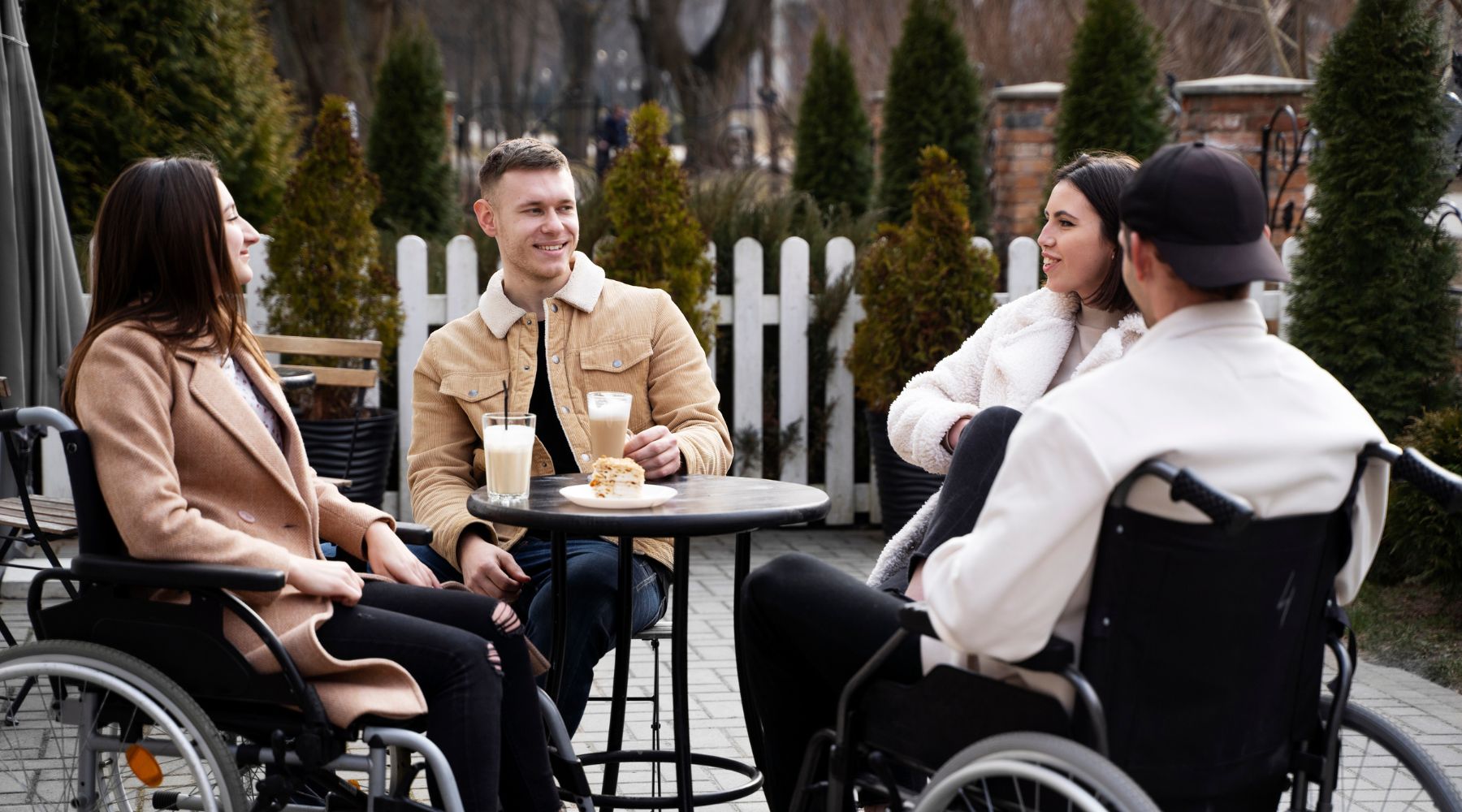group of people in wheelchairs discussing between manual and electric wheelchairs