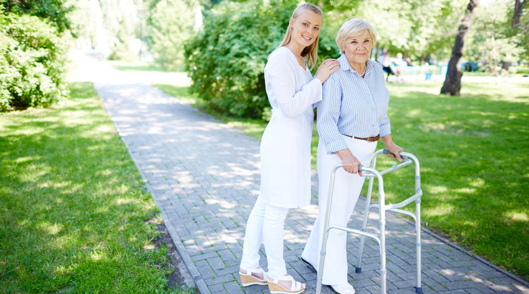 woman helping an elderly person choose a walking aid