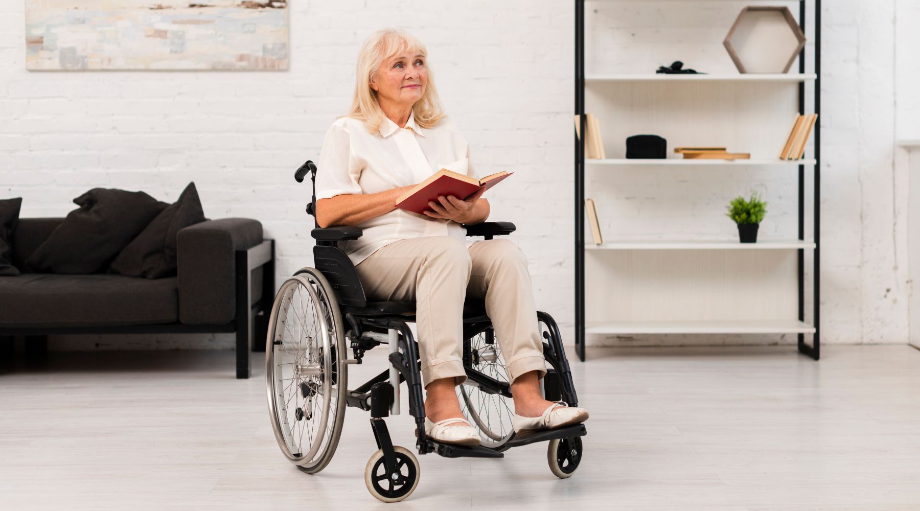 elderly woman sitting on a wheelchair while reading about tips on pressure injury when on a wheelchair