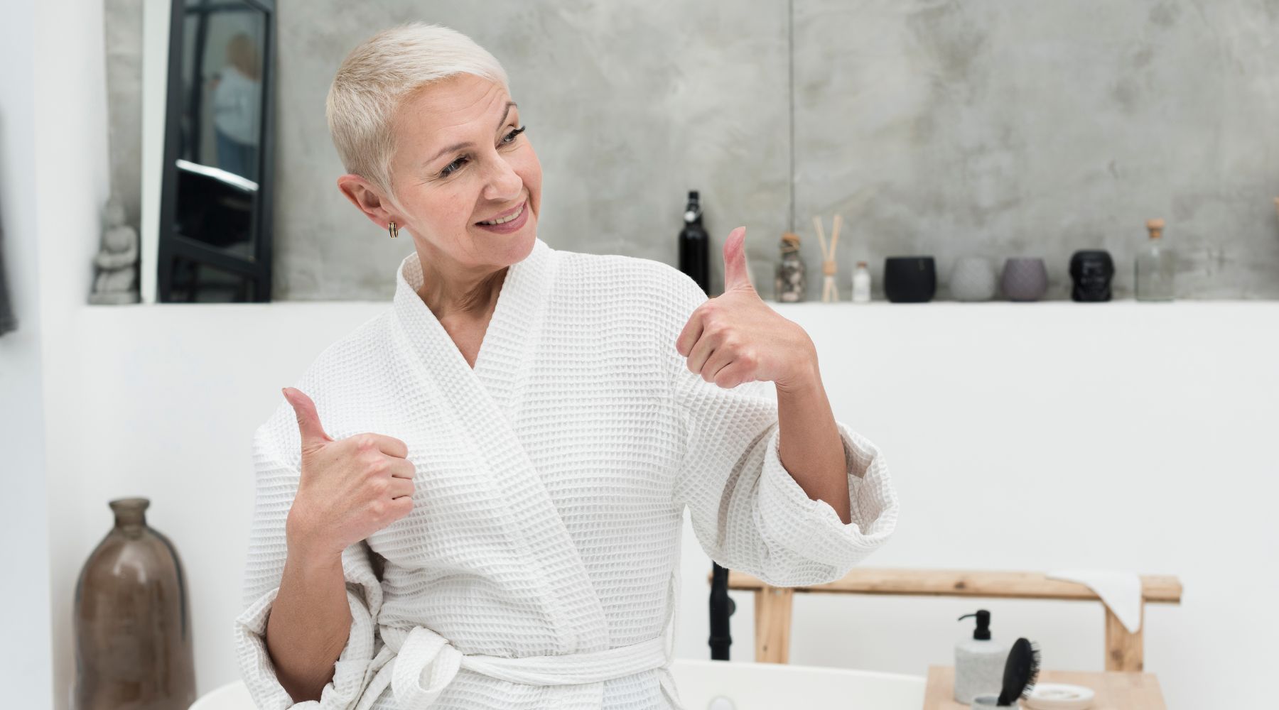 elderly woman doing a thumbs up in the bathroom because she's happy of her shower commode